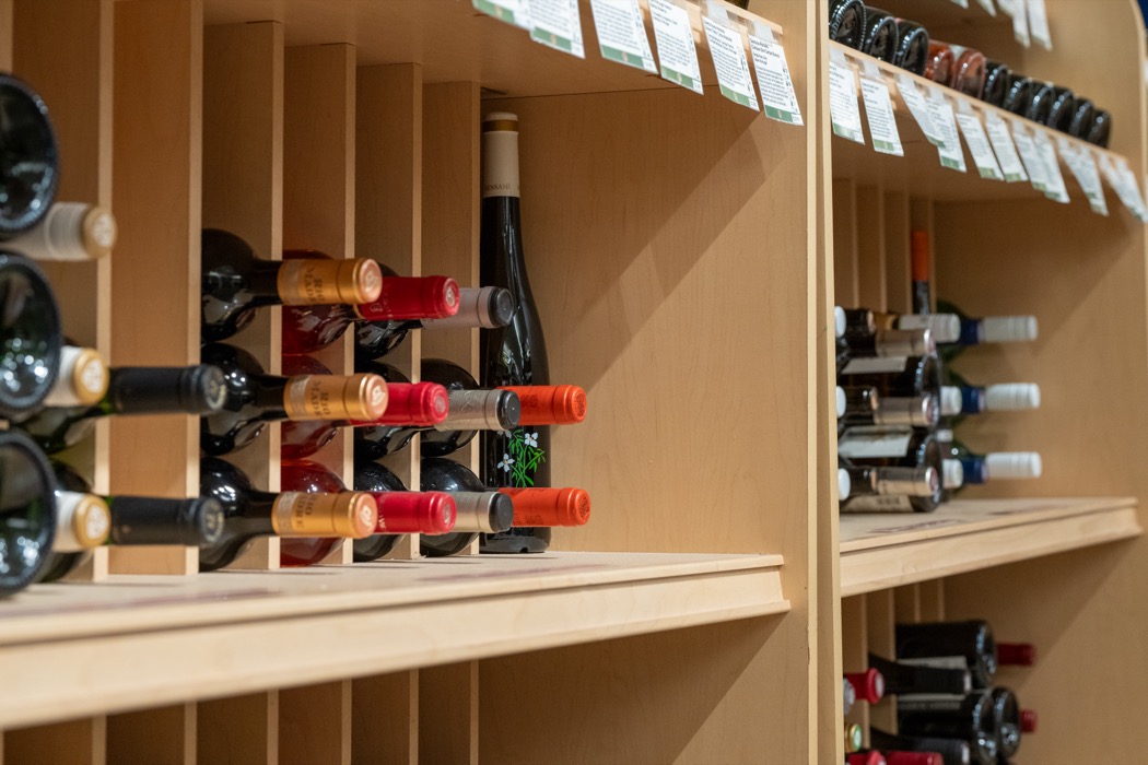 Close up of wine bottles on a shelf at the Friendly City Food Co-op