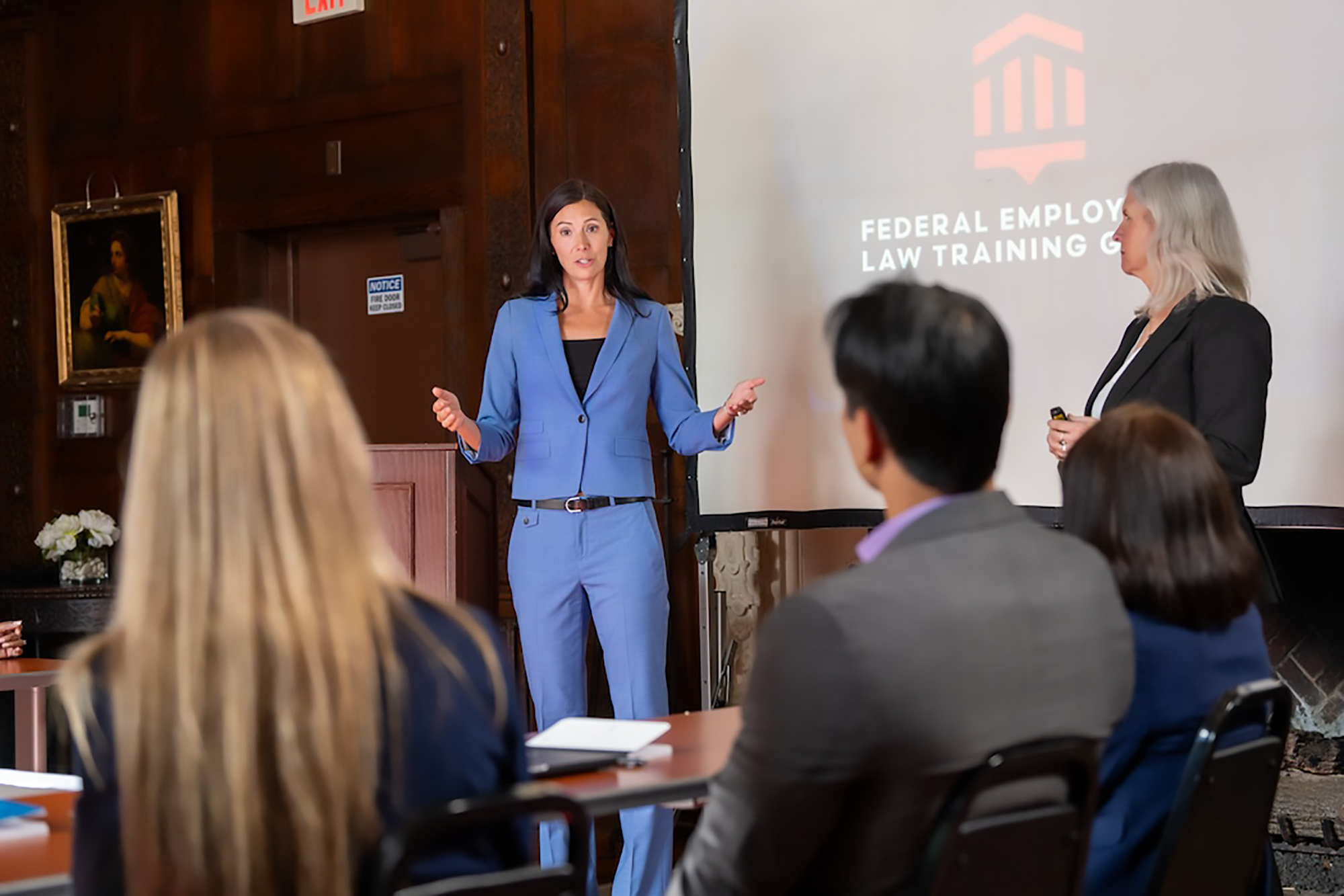 Federal Employment Law Training Group training session with two female instructors at front of room as students listen and learn.